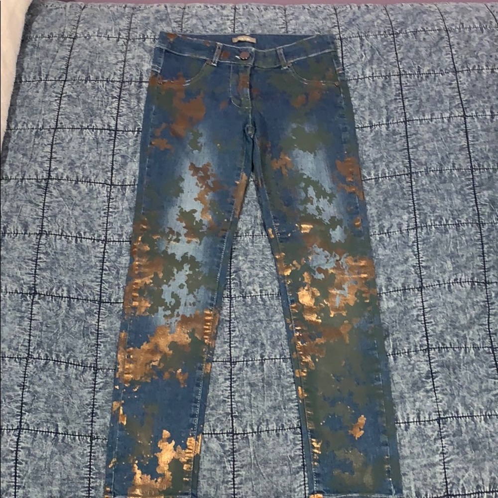 Blue jeans with gold and green splashes of color